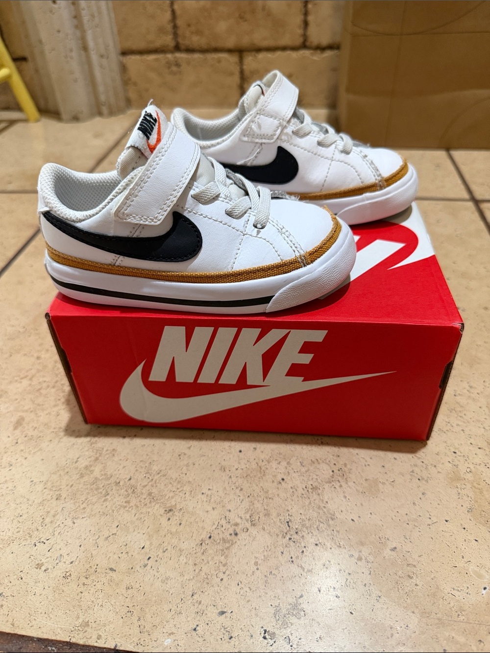 Nike Kids White Sneakers with Black Swoosh and Tan Trim